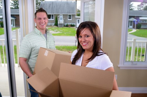 Removal team handling household items during a booked moving service