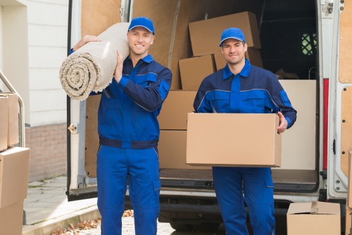 Man and van removals team loading furniture in Tooting