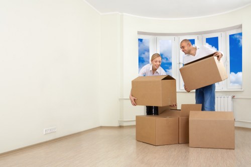 Loading furniture into a moving truck on a Tooting street