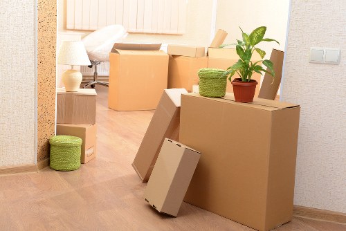 Packed moving boxes and furniture ready for transport during a home removal in Tooting