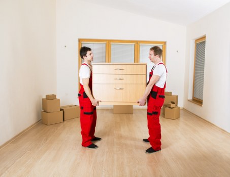 A moving team handling stairs and access in a Tooting property